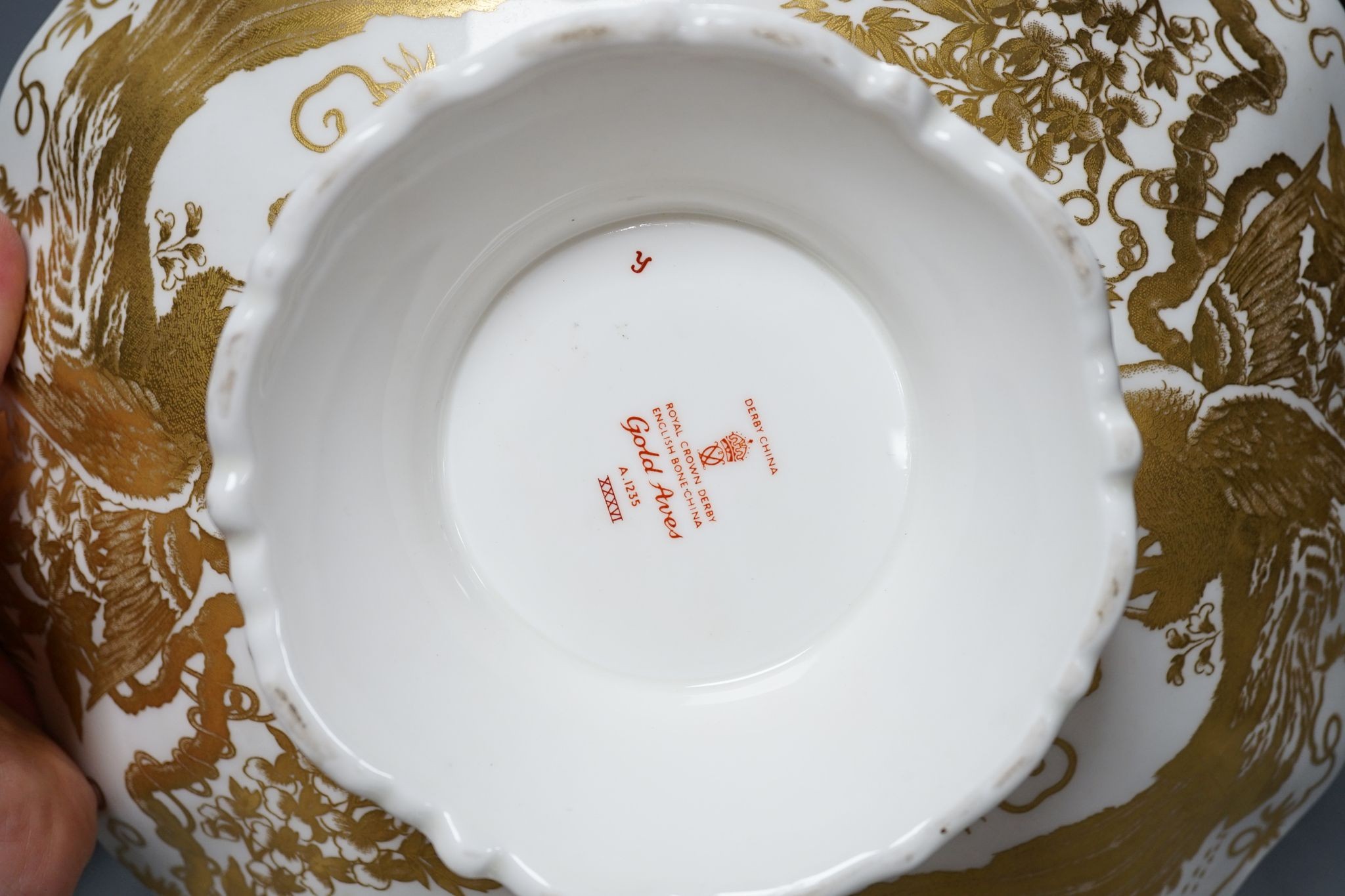 A Royal Crown Derby Imari bowl and two plates and another bowl, 25cm